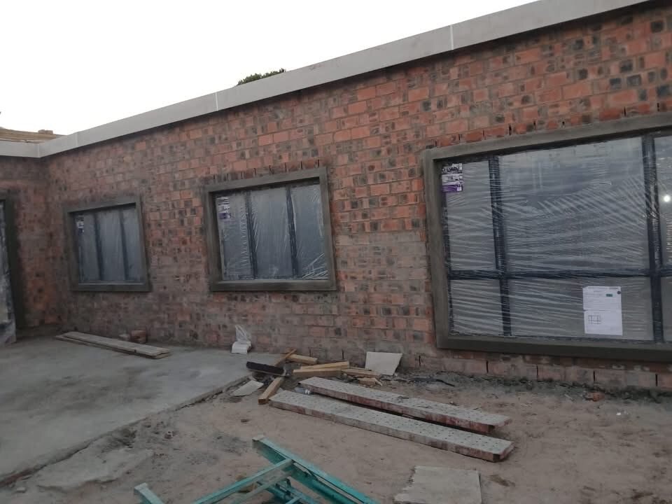 Black aluminium windows installed in a brick building
