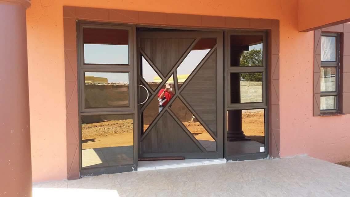 Custom double aluminium entrance door with geometric panels