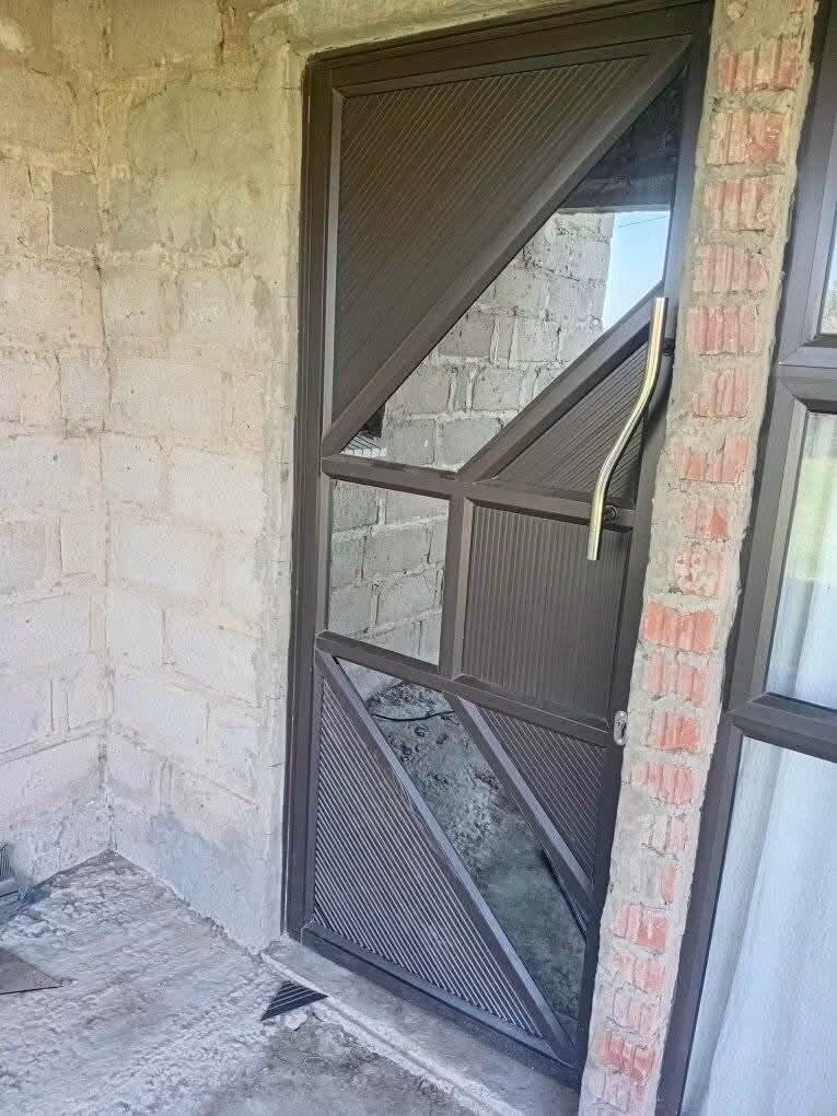 Custom aluminium security door with geometric openings