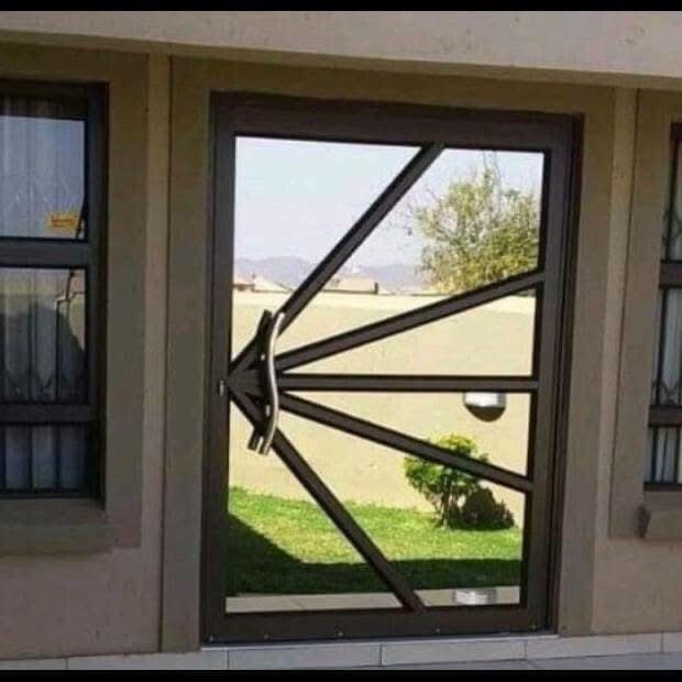 Black aluminium door with a custom radial pattern